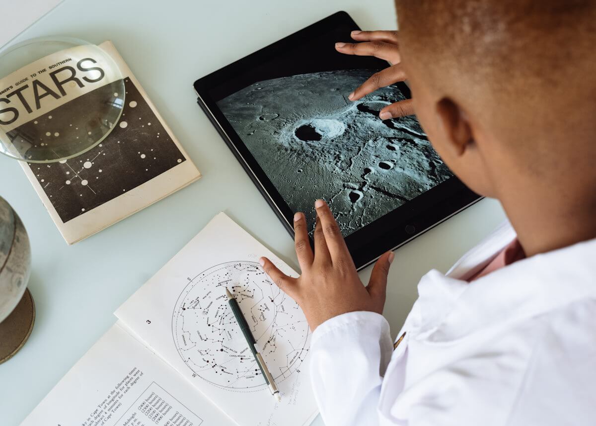 photo of a man studying astronomy on a tablet