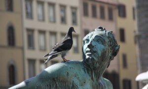 a statue with a pigeon