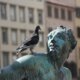 a statue with a pigeon