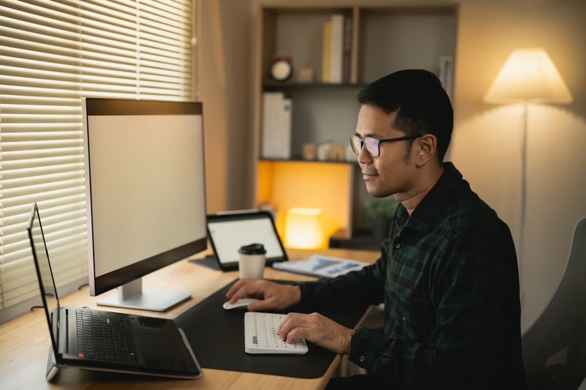 student sitting at pc and laptop